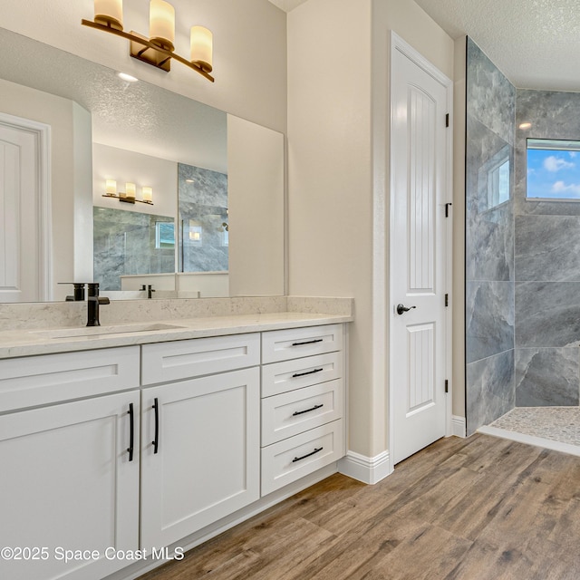 8025 Babcock St SE, Grant-Valkaria, FL 32909 - full bath featuring walk in shower, vanity, a textured ceiling, and wood finished floors