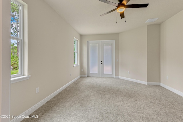 8025 Babcock St SE, Grant-Valkaria, FL 32909 - empty room featuring healthy amount of natural light, a ceiling fan, light colored carpet, and french doors