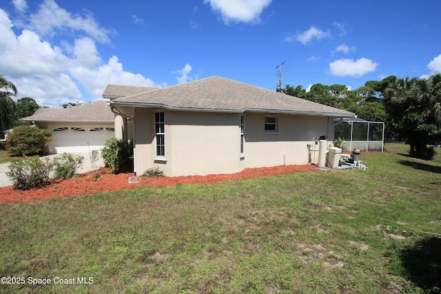 1366 17th Pl SW, Vero Beach, FL 32962 - view of property exterior featuring a garage, a lawn, stucco siding, and a shingled roof