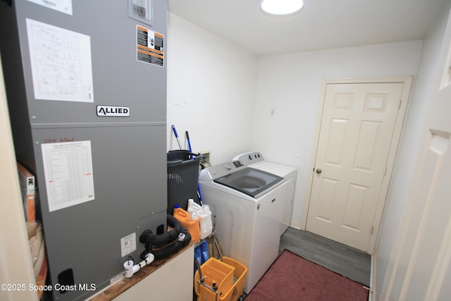 1366 17th Pl SW, Vero Beach, FL 32962 - washroom with heating unit, wood finished floors, and washing machine and dryer