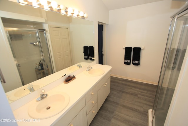 1366 17th Pl SW, Vero Beach, FL 32962 - full bath with double vanity, a stall shower, and wood finished floors
