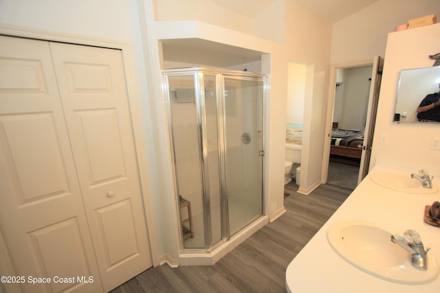 1366 17th Pl SW, Vero Beach, FL 32962 - bathroom featuring connected bathroom, wood finished floors, a stall shower, and double vanity