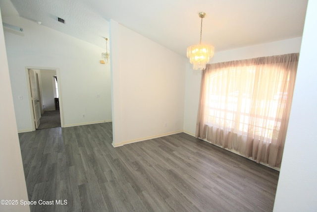 1366 17th Pl SW, Vero Beach, FL 32962 - spare room with a chandelier, wood finished floors, and lofted ceiling
