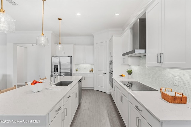 1052 Great Belt Cir, Melbourne, FL 32940 - kitchen with appliances with stainless steel finishes, wall chimney range hood, white cabinets, tasteful backsplash, and decorative light fixtures