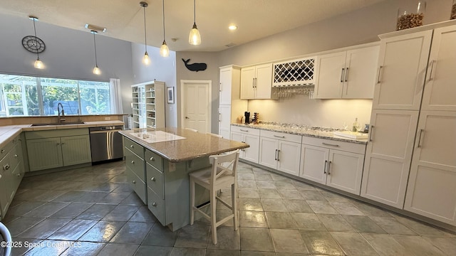 210 Pelican Dr, Melbourne Beach, FL 32951 - kitchen with stainless steel dishwasher, a kitchen island, white cabinetry, recessed lighting, and pendant lighting