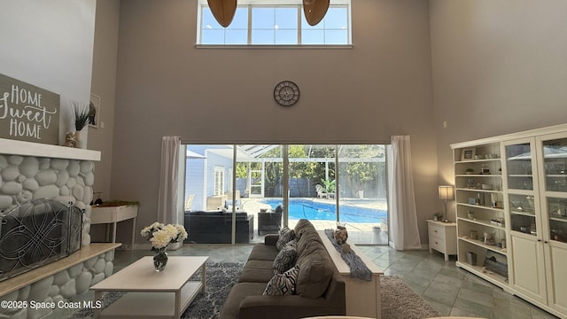 210 Pelican Dr, Melbourne Beach, FL 32951 - living room featuring a towering ceiling, a sunroom, and ceiling fan