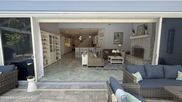 210 Pelican Dr, Melbourne Beach, FL 32951 - living room with stairway and a stone fireplace