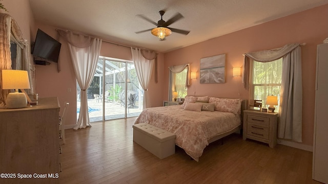 210 Pelican Dr, Melbourne Beach, FL 32951 - bedroom featuring access to exterior, light wood-type flooring, and a ceiling fan