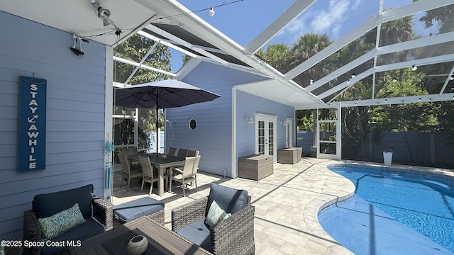 210 Pelican Dr, Melbourne Beach, FL 32951 - view of swimming pool with french doors, a patio area, glass enclosure, and outdoor dining area