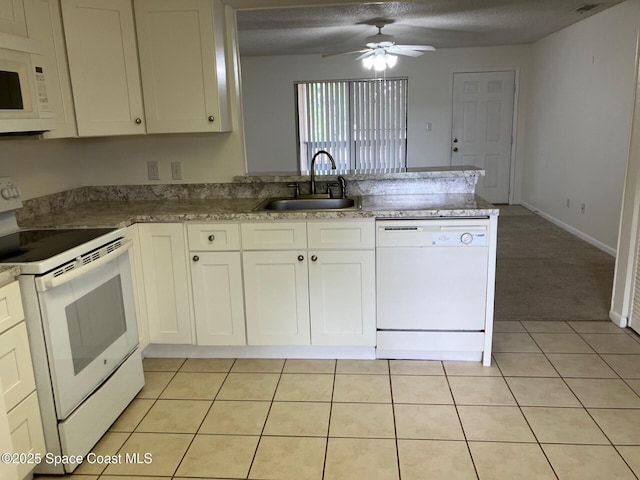 1515 Huntington Ln Unit 223, Rockledge, FL 32955 - kitchen with white appliances, a peninsula, a ceiling fan, white cabinetry, and a textured ceiling