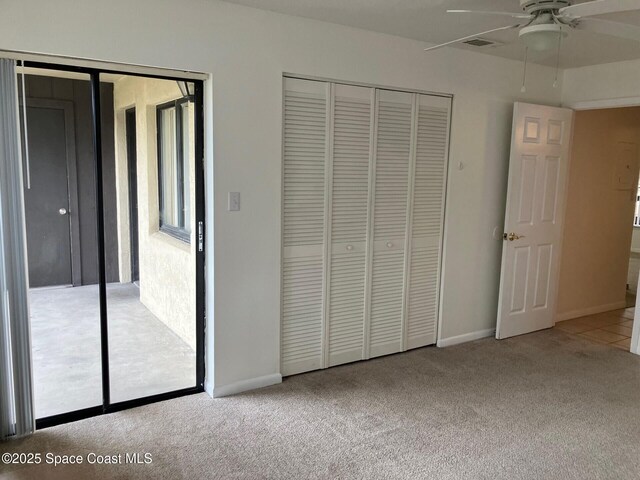 1515 Huntington Ln Unit 223, Rockledge, FL 32955 - unfurnished bedroom featuring carpet flooring, a closet, and a ceiling fan