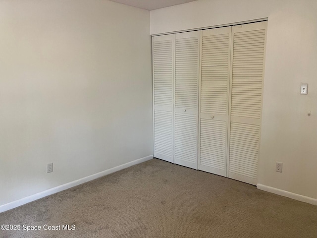 1515 Huntington Ln Unit 223, Rockledge, FL 32955 - unfurnished bedroom featuring carpet floors and a closet