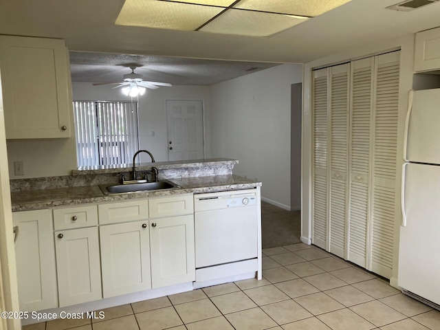 1515 Huntington Ln Unit 223, Rockledge, FL 32955 - kitchen featuring white appliances, a peninsula, a ceiling fan, and white cabinetry