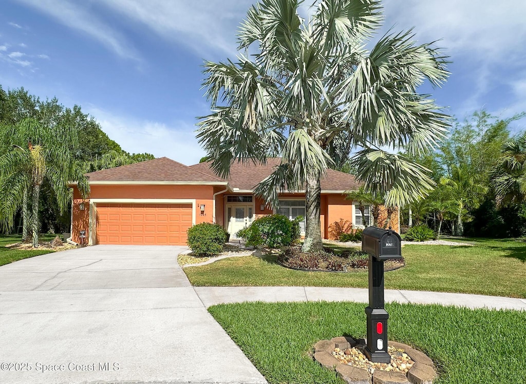 1045 Worthington Spring Dr, Melbourne, FL 32940 - single story home featuring a garage, a front yard, concrete driveway, and stucco siding