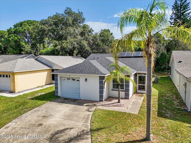 3116 Winchester Dr, Cocoa, FL 32926 - ranch-style home with a shingled roof, a garage, concrete driveway, and solar panels