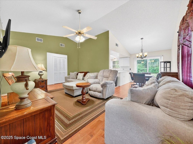 3116 Winchester Dr, Cocoa, FL 32926 - living area featuring lofted ceiling, a chandelier, a textured ceiling, wood finished floors, and a ceiling fan