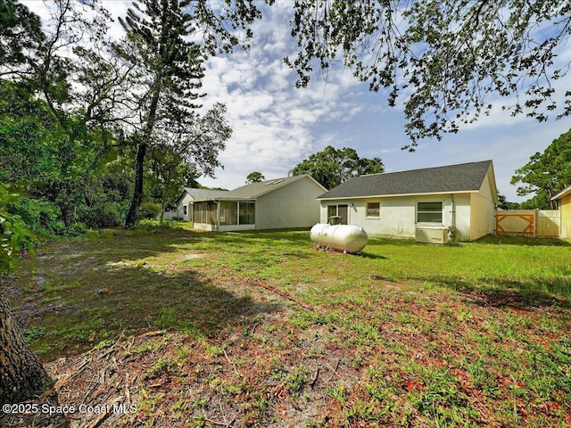 3116 Winchester Dr, Cocoa, FL 32926 - rear view of property with a sunroom and stucco siding