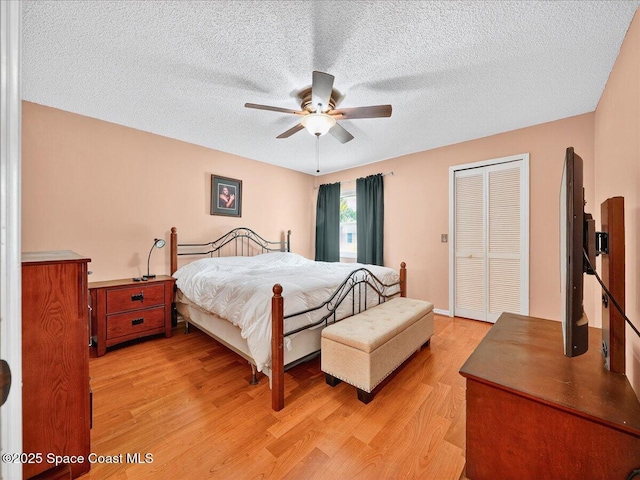 3116 Winchester Dr, Cocoa, FL 32926 - bedroom with light wood-style flooring, a closet, a textured ceiling, and ceiling fan