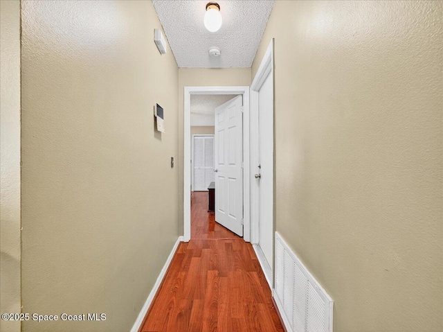 3116 Winchester Dr, Cocoa, FL 32926 - hall with wood finished floors and a textured ceiling