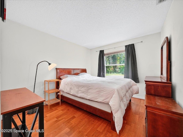 3116 Winchester Dr, Cocoa, FL 32926 - bedroom with a textured ceiling and light wood-style flooring