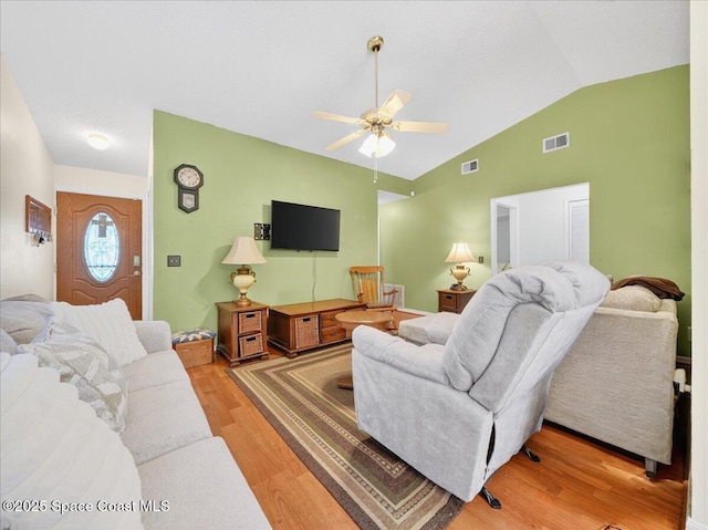 3116 Winchester Dr, Cocoa, FL 32926 - living area with vaulted ceiling, light wood finished floors, and a ceiling fan