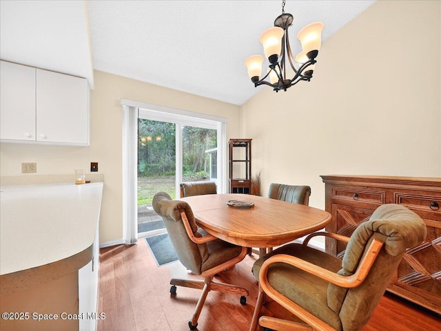 3116 Winchester Dr, Cocoa, FL 32926 - dining space with vaulted ceiling, a chandelier, and light wood finished floors