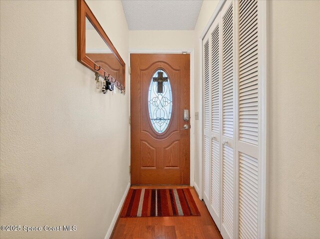 3116 Winchester Dr, Cocoa, FL 32926 - doorway with wood finished floors and baseboards