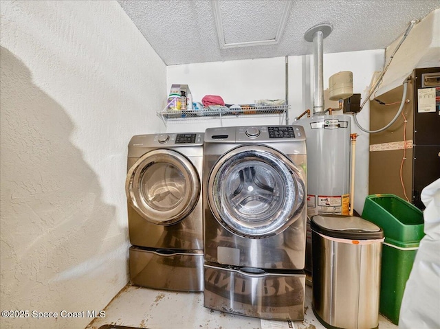 3116 Winchester Dr, Cocoa, FL 32926 - laundry area featuring washer and clothes dryer, water heater, a textured ceiling, and a textured wall