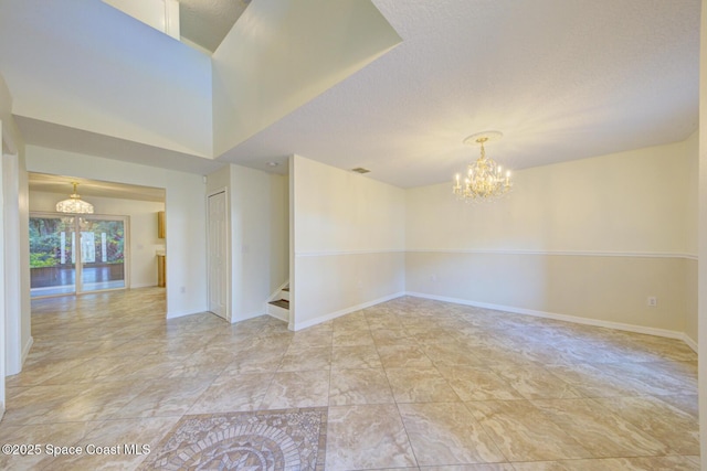 6065 Balboa St, Cocoa, FL 32927 - unfurnished room with a chandelier, stairs, a textured ceiling, and light marble finish flooring