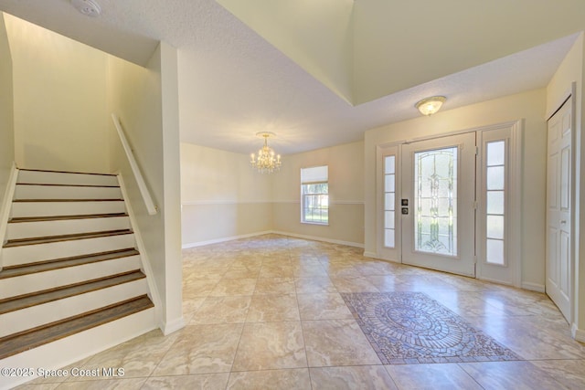 6065 Balboa St, Cocoa, FL 32927 - foyer entrance with a chandelier, stairs, and light marble finish floors