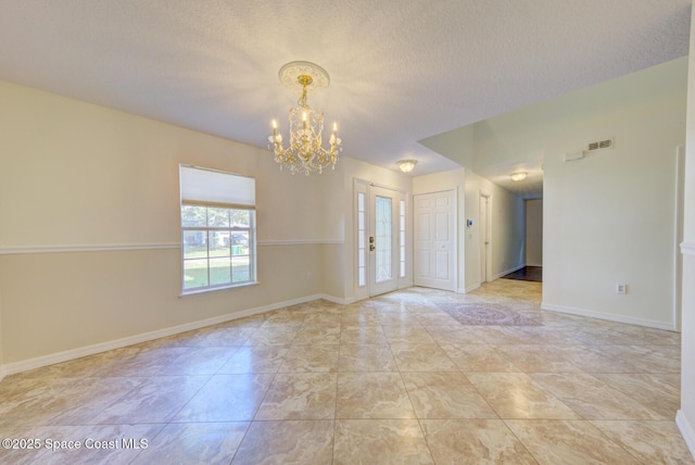 6065 Balboa St, Cocoa, FL 32927 - unfurnished room with a chandelier and a textured ceiling