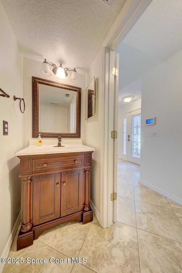 6065 Balboa St, Cocoa, FL 32927 - bathroom with vanity and a textured ceiling