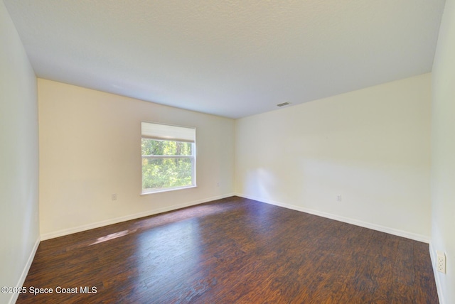 6065 Balboa St, Cocoa, FL 32927 - spare room with dark wood-style flooring and baseboards