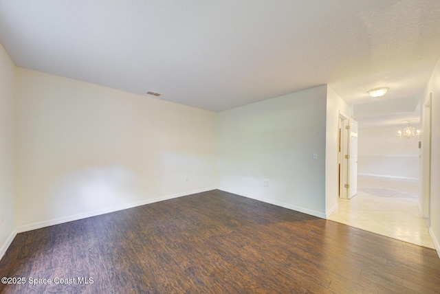 6065 Balboa St, Cocoa, FL 32927 - spare room featuring a chandelier and wood finished floors