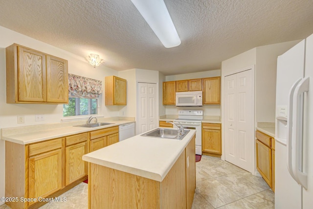 6065 Balboa St, Cocoa, FL 32927 - kitchen featuring white appliances, a textured ceiling, an island with sink, light countertops, and light tile patterned flooring