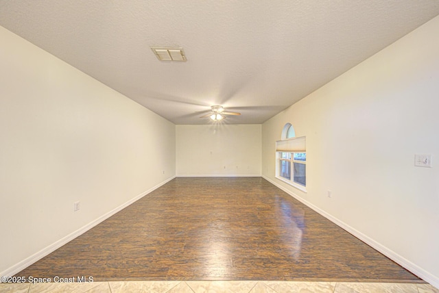 6065 Balboa St, Cocoa, FL 32927 - empty room with ceiling fan, dark wood-style flooring, and a textured ceiling