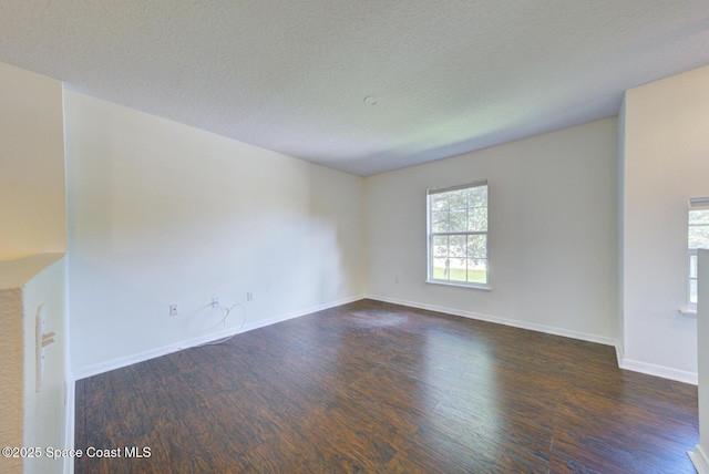 6065 Balboa St, Cocoa, FL 32927 - unfurnished room featuring dark wood-style flooring and a textured ceiling