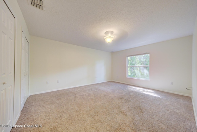 6065 Balboa St, Cocoa, FL 32927 - unfurnished bedroom with carpet floors and a textured ceiling