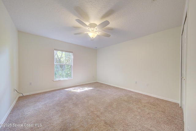 6065 Balboa St, Cocoa, FL 32927 - spare room featuring light colored carpet, a ceiling fan, and a textured ceiling