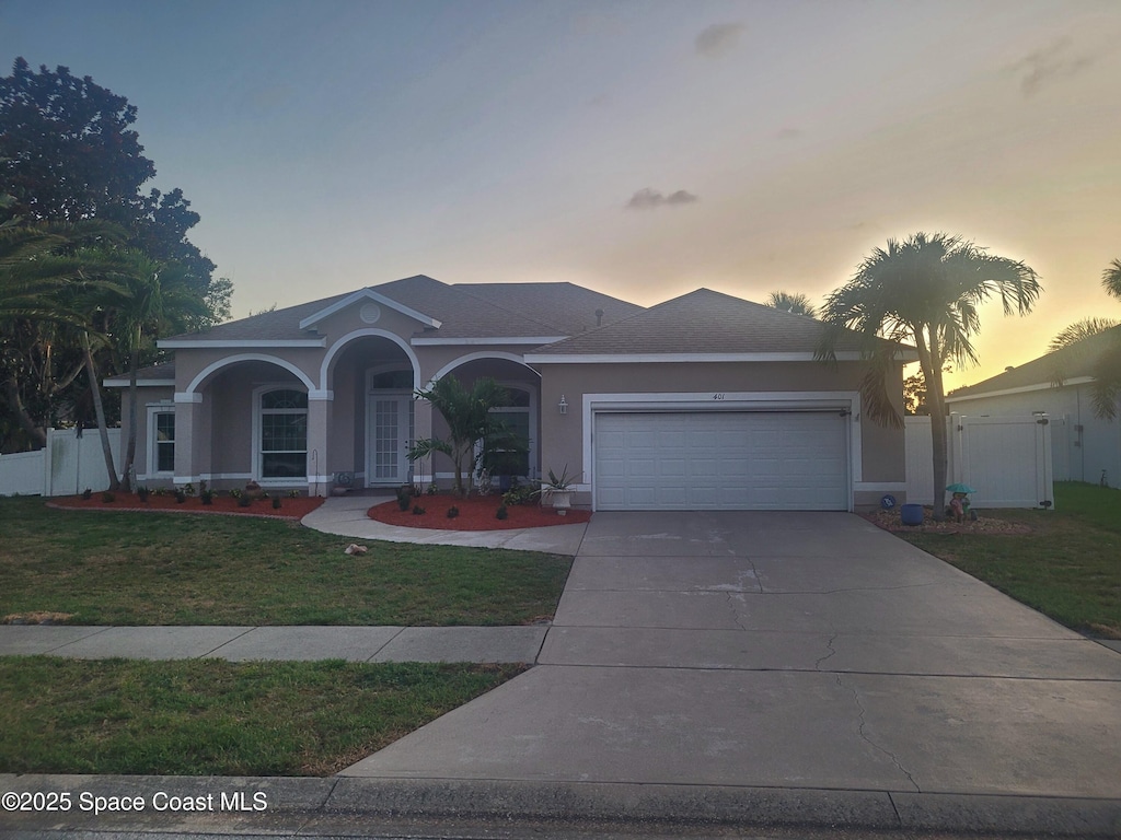 401 Stonehenge Cir, Rockledge, FL 32955 - ranch-style home featuring a garage, stucco siding, and driveway
