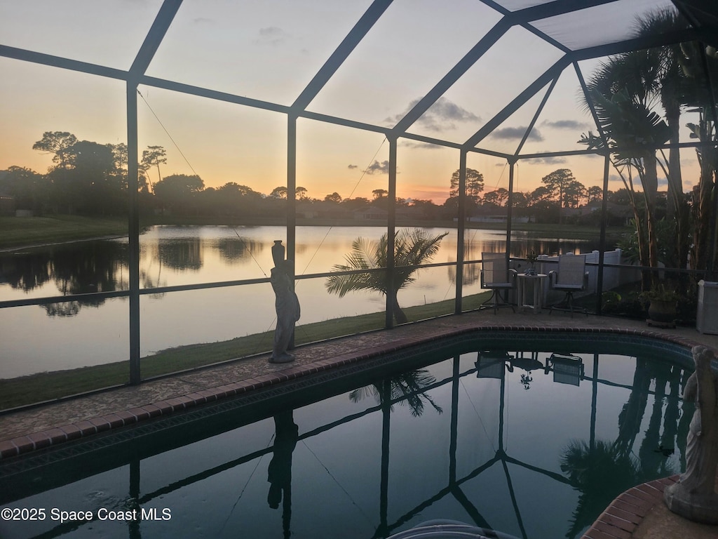 401 Stonehenge Cir, Rockledge, FL 32955 - pool at dusk featuring a lanai, an outdoor pool, and a patio