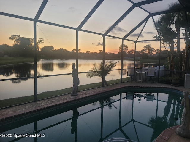 401 Stonehenge Cir, Rockledge, FL 32955 - pool at dusk featuring a lanai, an outdoor pool, and a patio