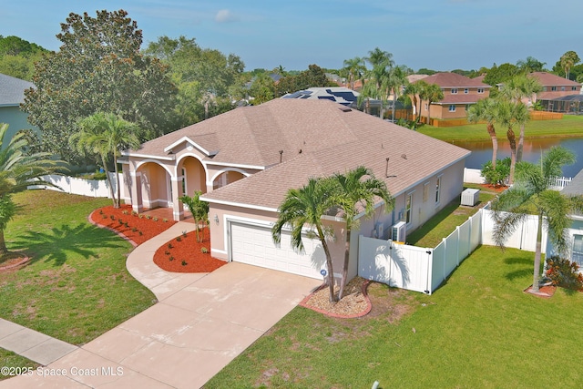401 Stonehenge Cir, Rockledge, FL 32955 - mediterranean / spanish house with an attached garage, stucco siding, driveway, and a water view