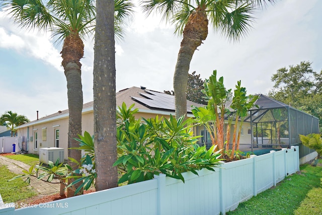 401 Stonehenge Cir, Rockledge, FL 32955 - view of home's exterior featuring a fenced backyard and glass enclosure