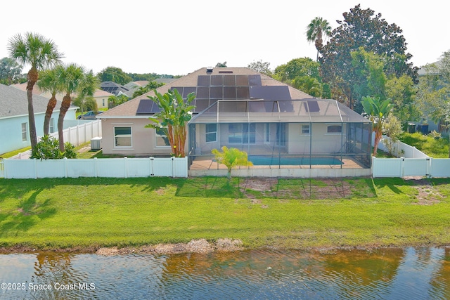 401 Stonehenge Cir, Rockledge, FL 32955 - rear view of house featuring a fenced backyard, a water view, solar panels, and a patio area