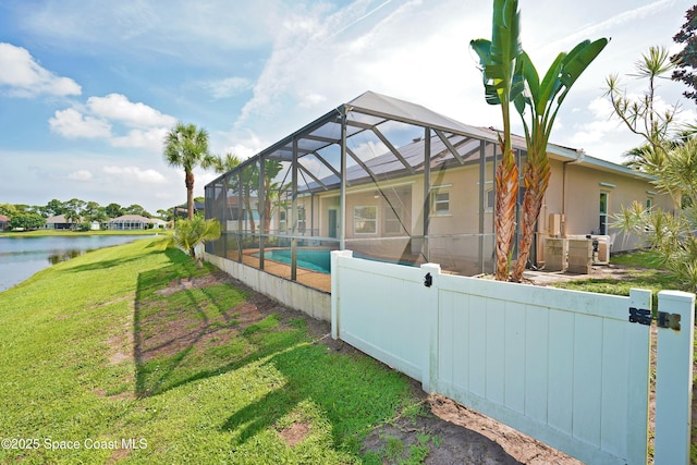 401 Stonehenge Cir, Rockledge, FL 32955 - rear view of property featuring an outdoor pool, stucco siding, a water view, and a lanai