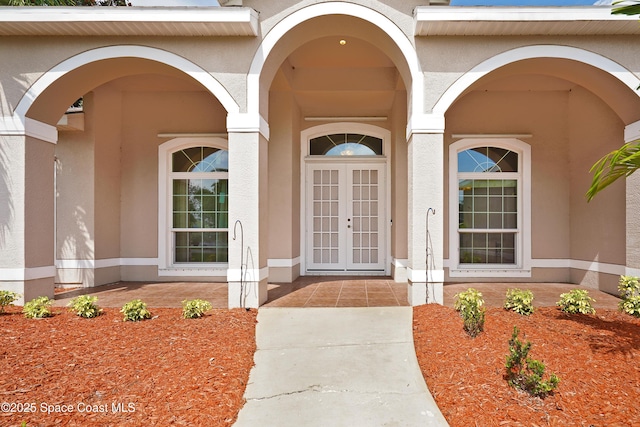 401 Stonehenge Cir, Rockledge, FL 32955 - view of exterior entry with stucco siding, french doors, and covered porch
