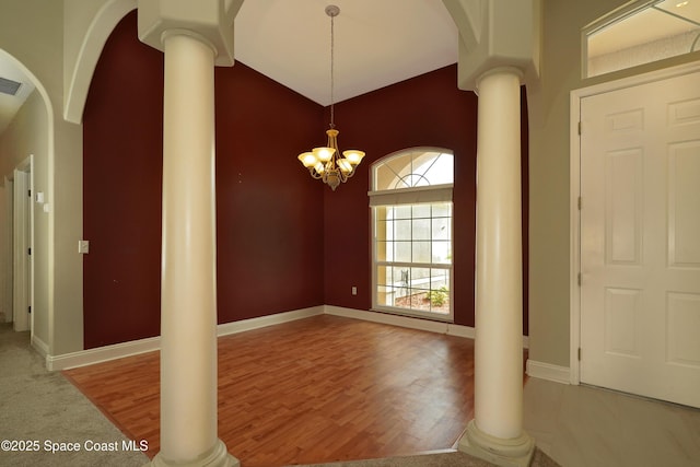 401 Stonehenge Cir, Rockledge, FL 32955 - foyer entrance featuring ornate columns, wood finished floors, arched walkways, and high vaulted ceiling