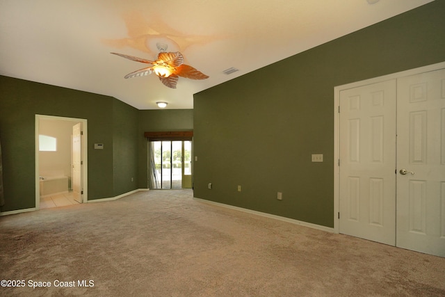401 Stonehenge Cir, Rockledge, FL 32955 - unfurnished bedroom featuring light colored carpet, connected bathroom, and ceiling fan