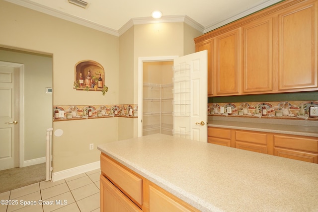 401 Stonehenge Cir, Rockledge, FL 32955 - kitchen with light tile patterned floors, crown molding, and light countertops